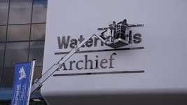 766 Belettering nieuw logo Waterlands Archief, Monteurs brengen het nieuwe logo aan van het Waterlands Archief, 2023.